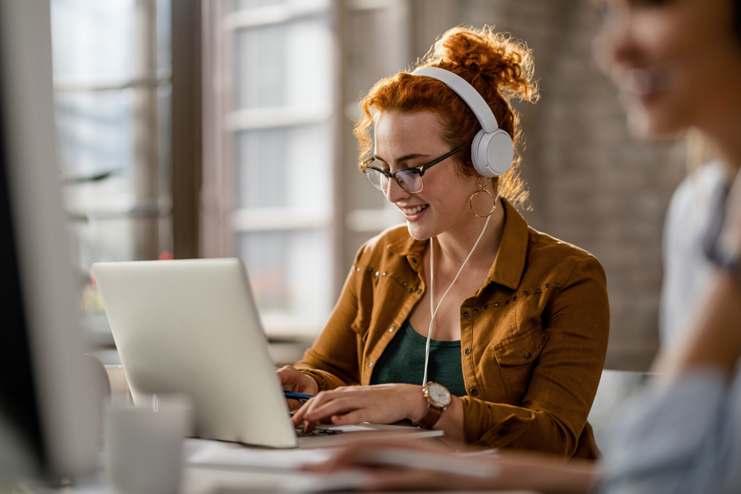 Homepage Smiling Creative Businesswoman Listening Music Headphones While Working Computer Office Scaled